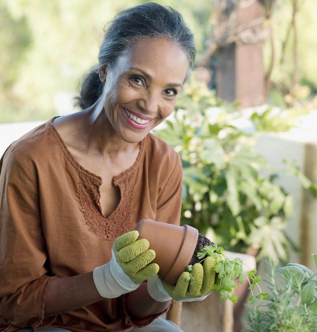 Patelco member Krystal repots a plant in her garden.